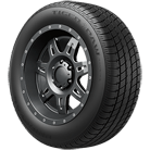 A close up of a tire with a black rim on a white background.