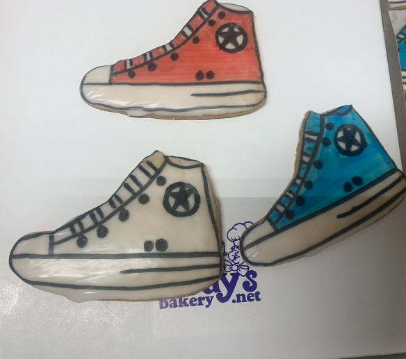 Three colorful cartoon sneakers: red, gray, and blue on a white background.