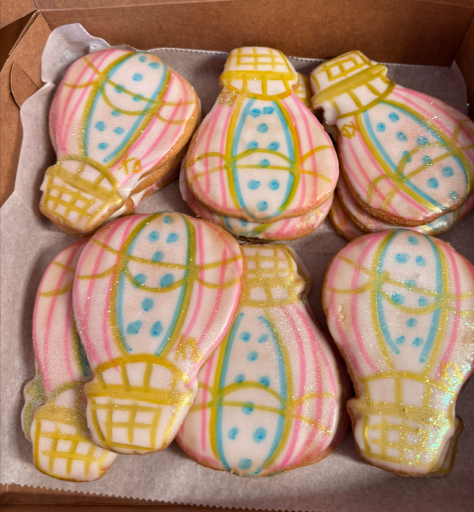 Box of pastel hot-air-balloon-shaped cookies with pink, yellow, and blue icing
