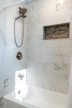 A bathroom with a shower and a bathtub.