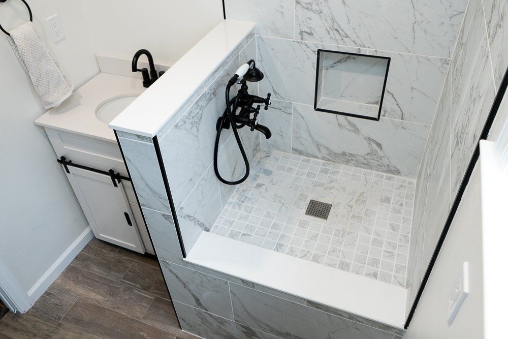 A bathroom with a dog washing station and a sink.