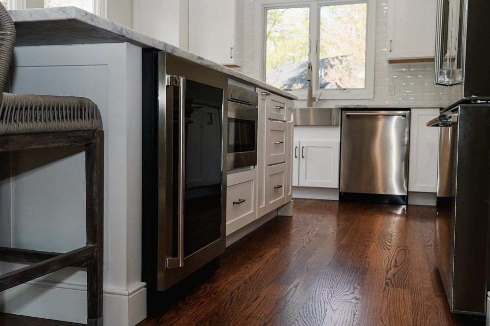 A kitchen with stainless steel appliances and hardwood floors.