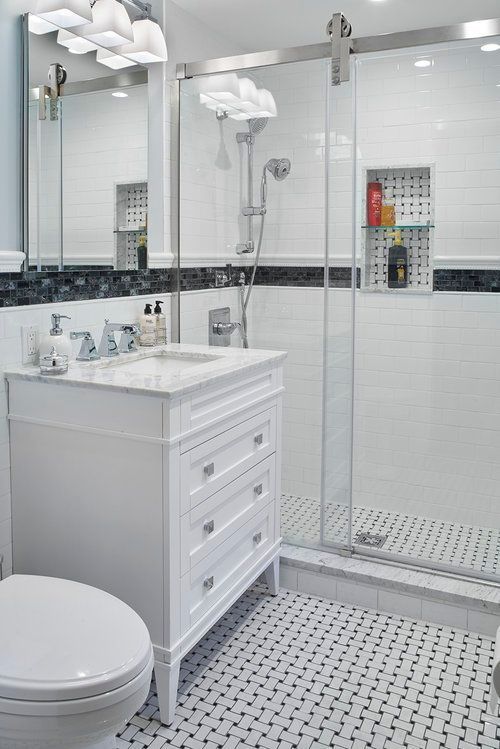 A bathroom with a toilet , sink , mirror and shower.