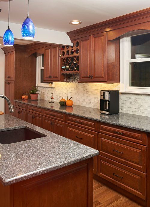 A kitchen with wooden cabinets and granite counter tops