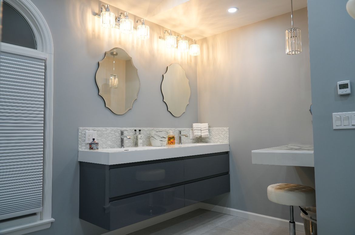 A close up of a bathroom sink with water running from the faucet.