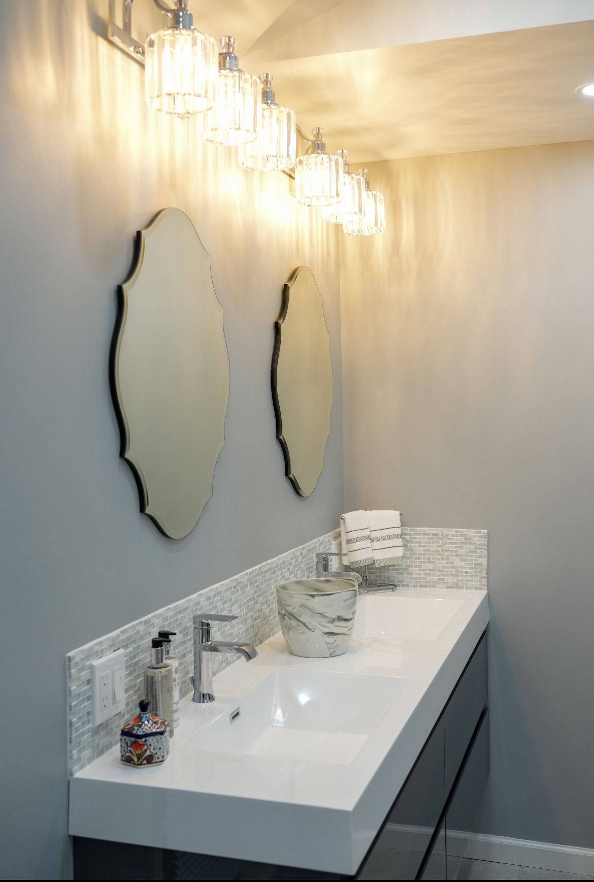 A bathroom with two sinks and two mirrors.
