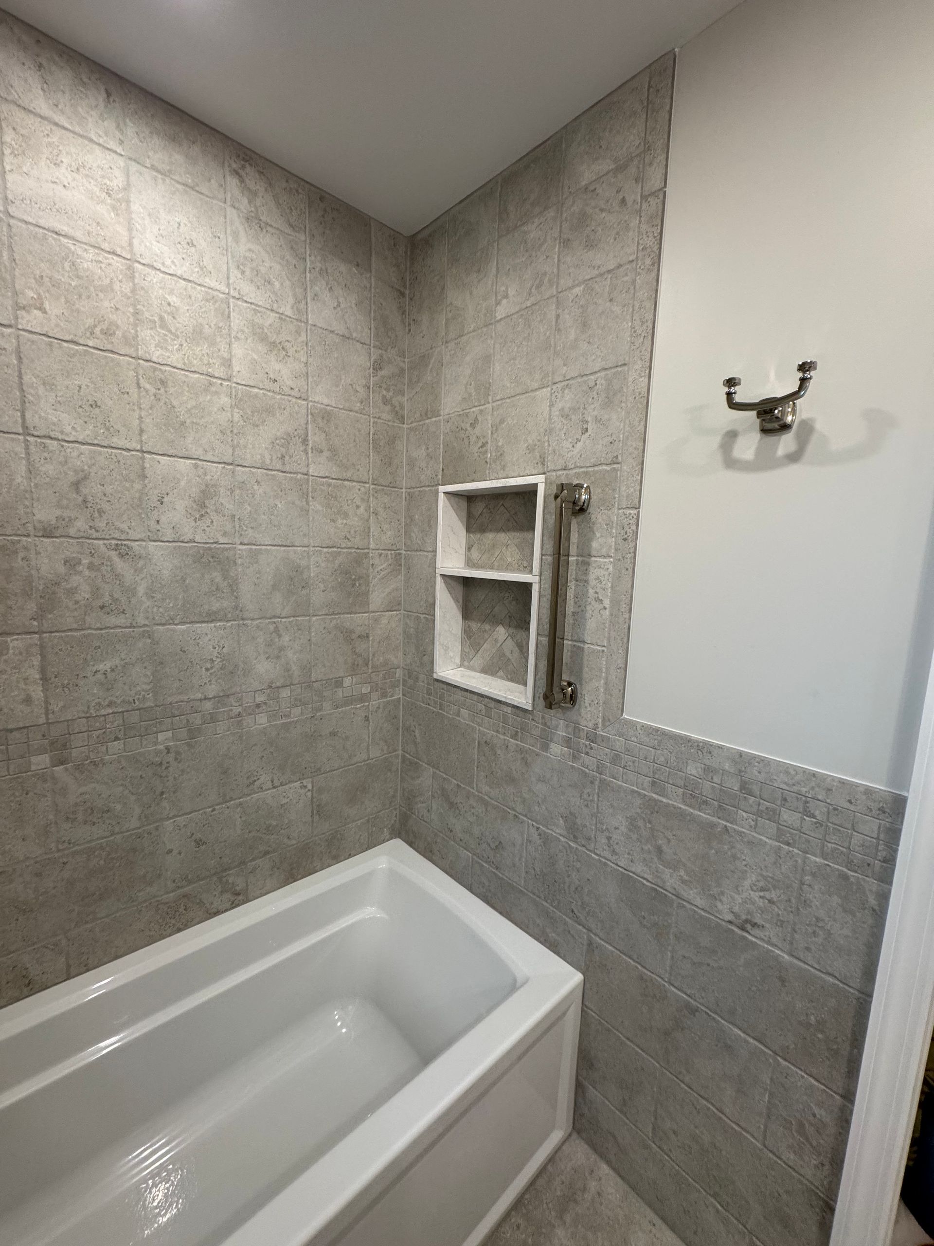 A bathroom with a bathtub and a shower.