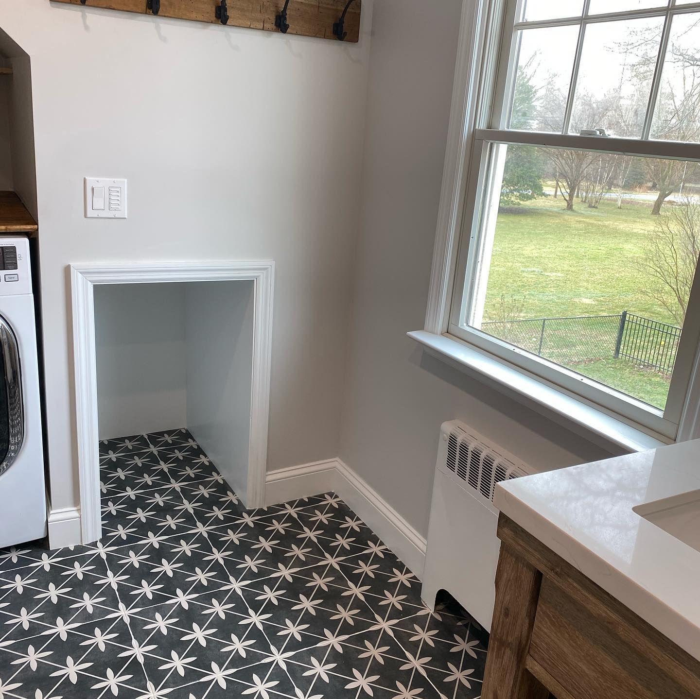 A laundry room with a washer and dryer and a window.