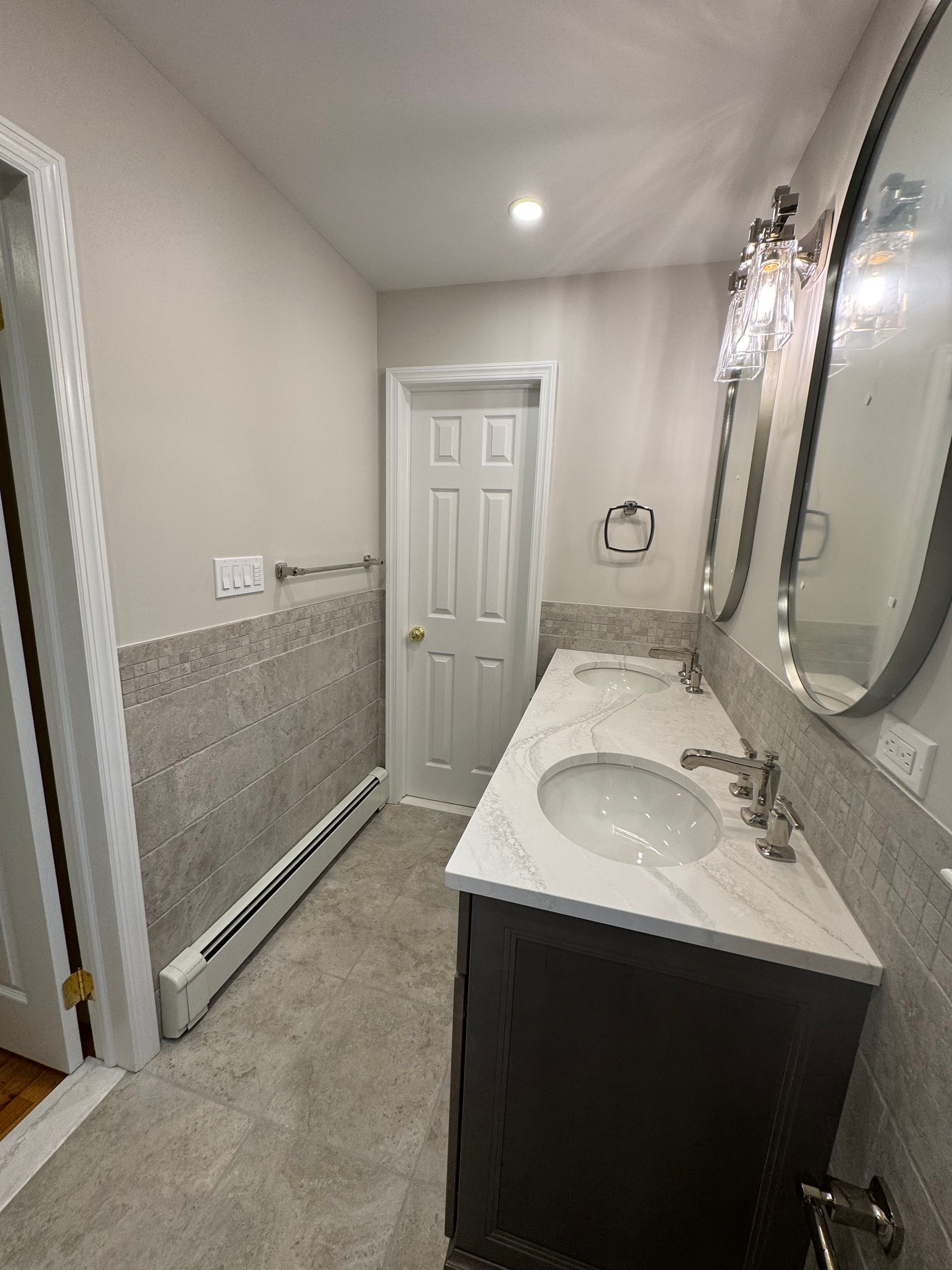 A bathroom with two sinks and two mirrors.