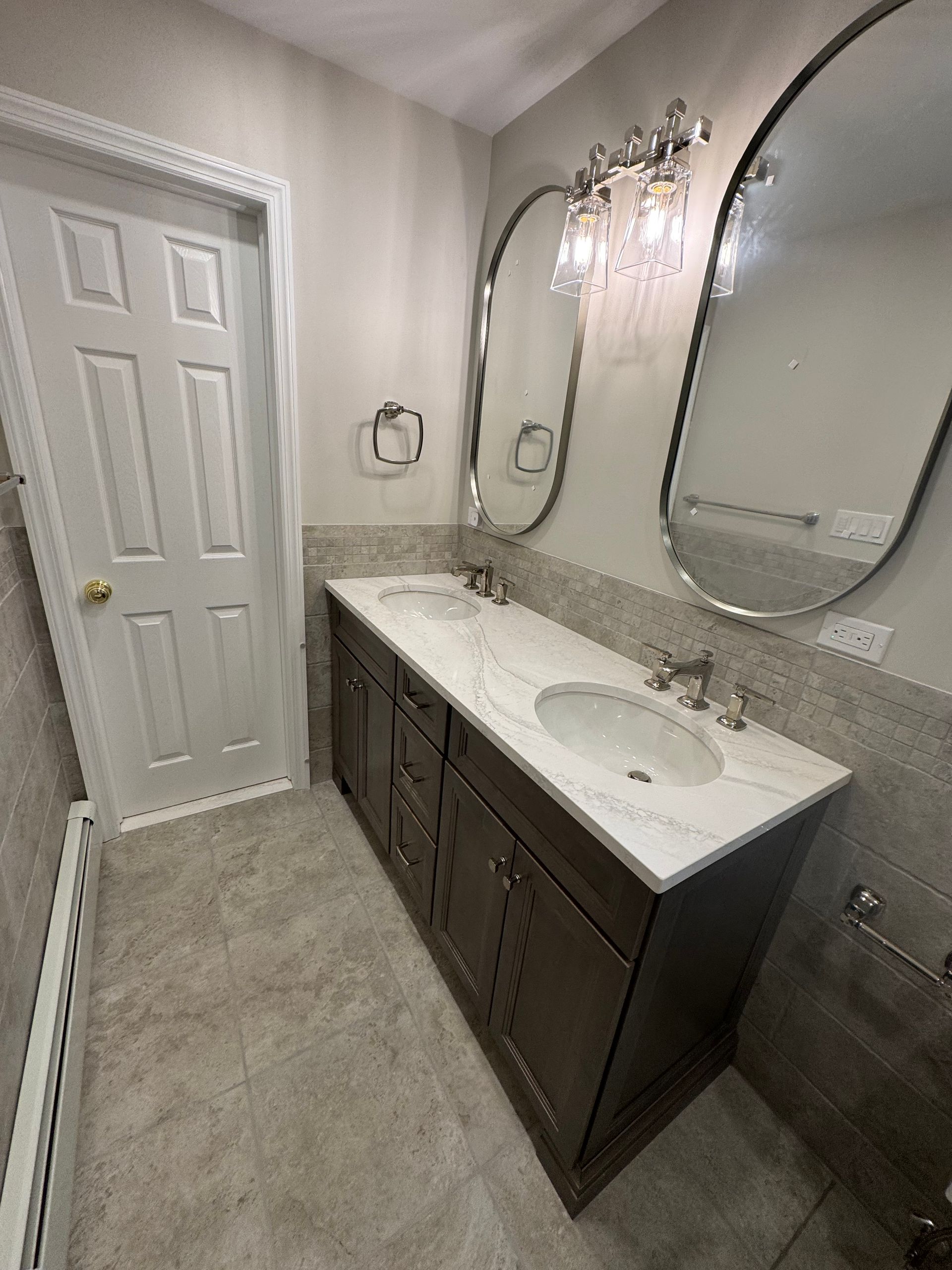 A bathroom with two sinks and two mirrors.