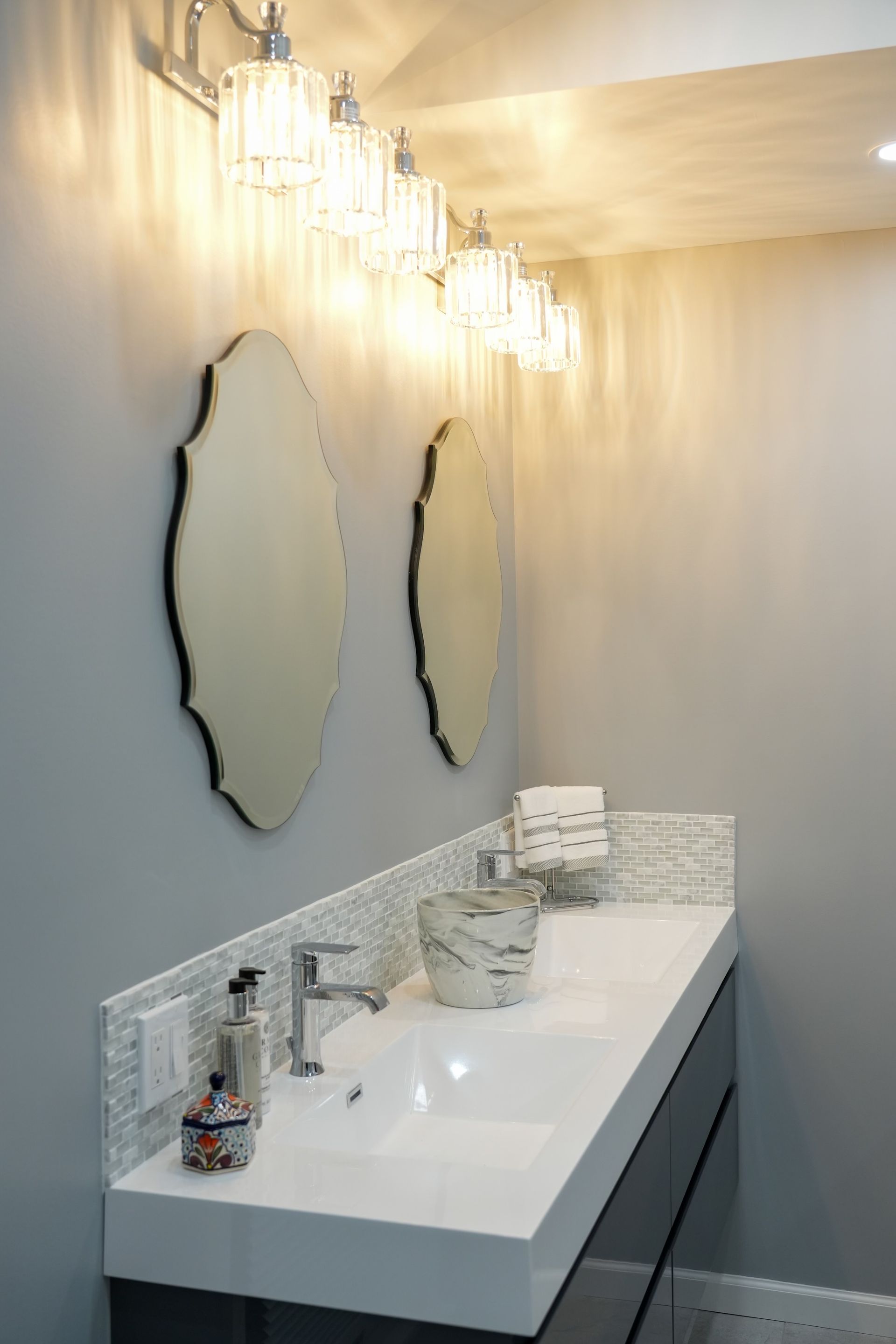 A bathroom with two sinks and two mirrors.