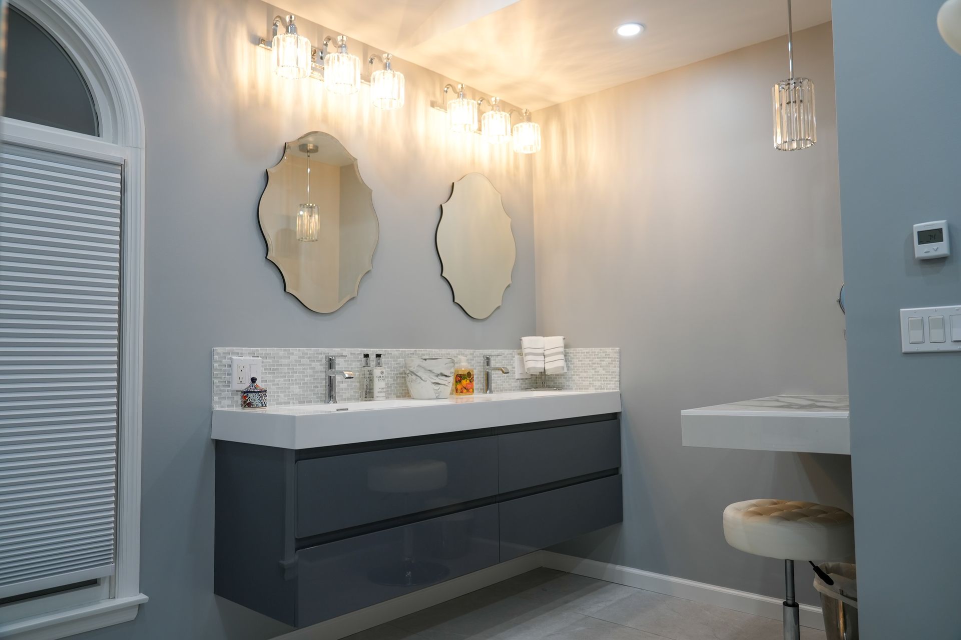 A bathroom with two sinks and two mirrors.