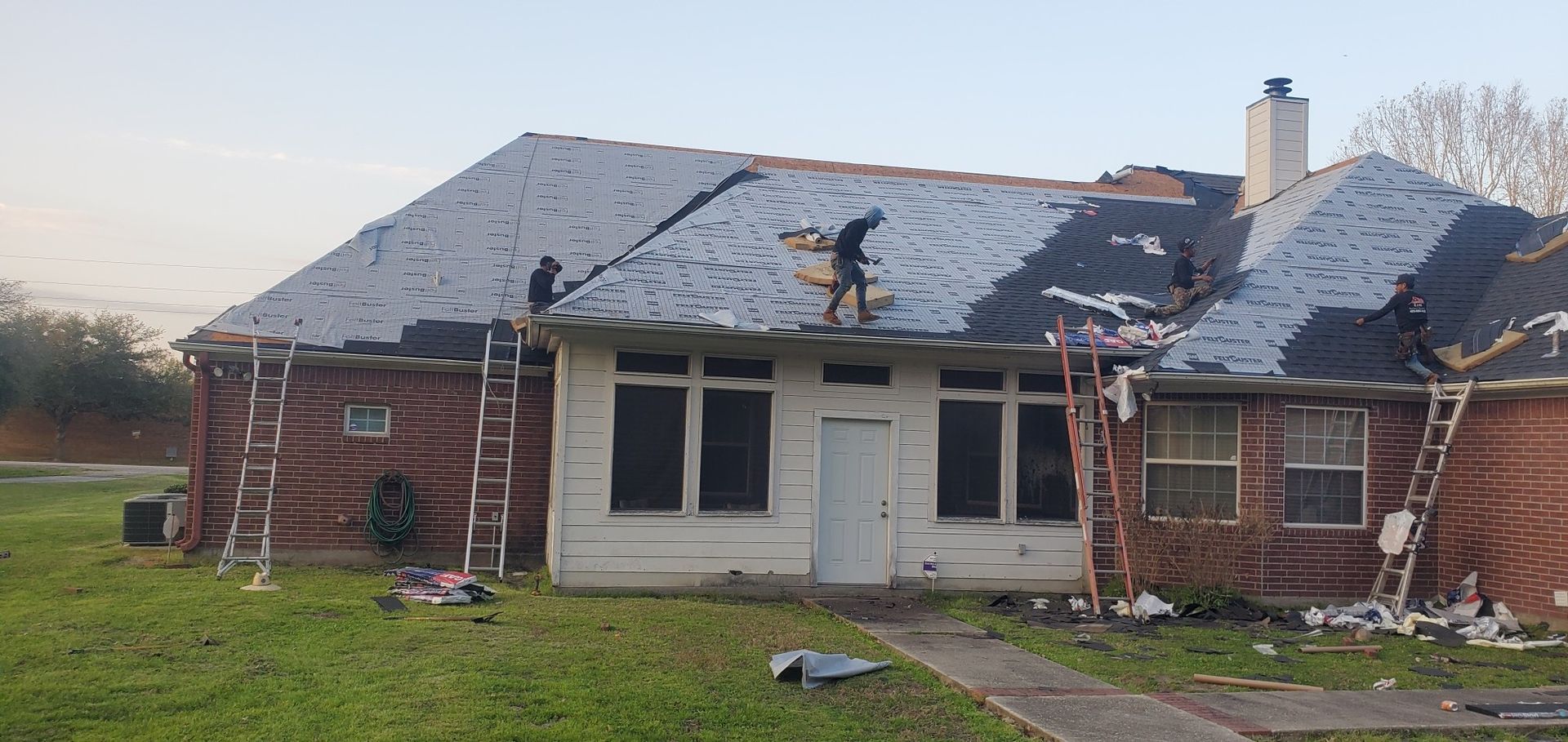 A house is being remodeled with a roof being installed.