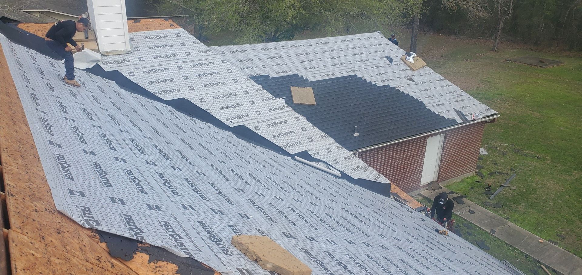 A man is working on the roof of a house.