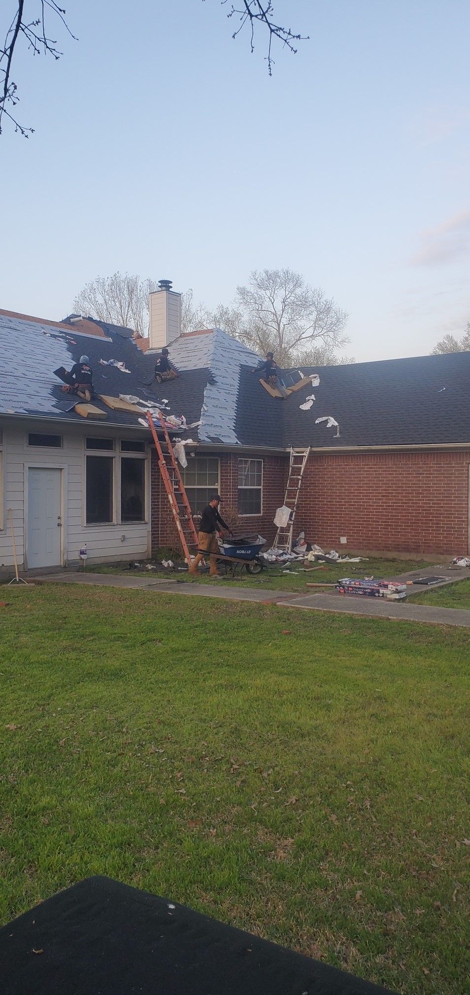 A house with a roof that has been damaged by a tornado.