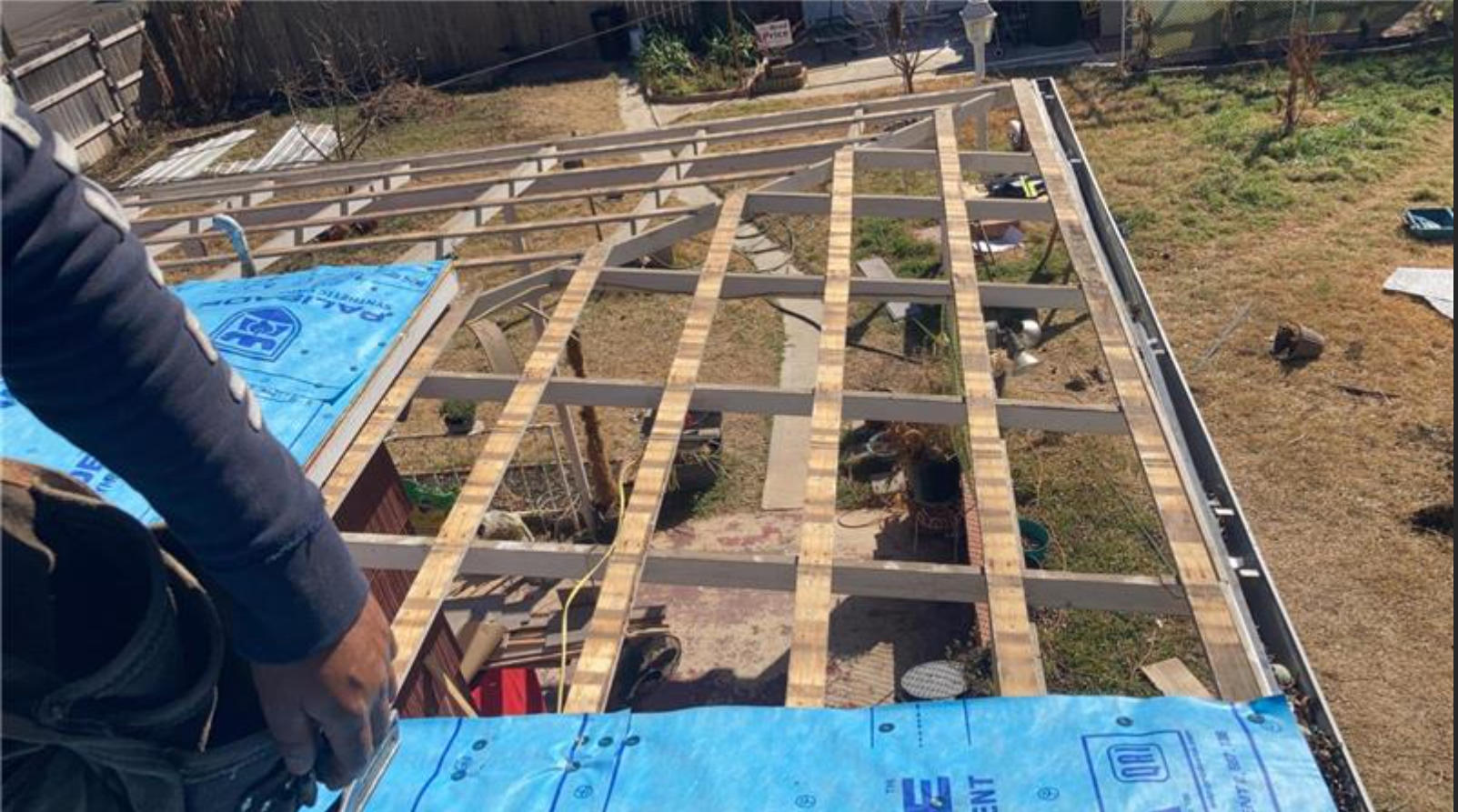 A person is standing on top of a wooden structure.