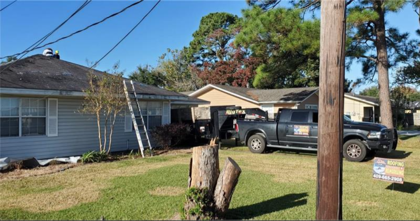 A black truck is parked in front of a house.
