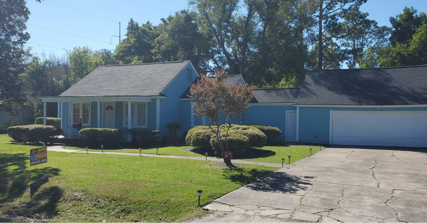 A blue house with a black roof.