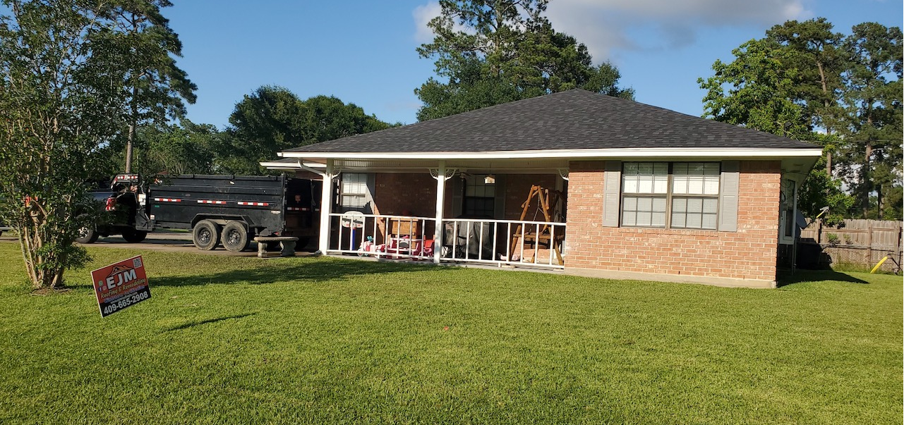 A brick house with a black truck parked in front of it.
