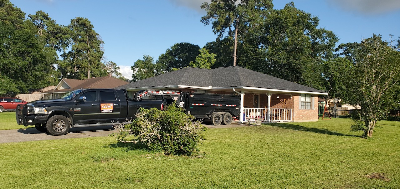 A black truck is parked in front of a house.