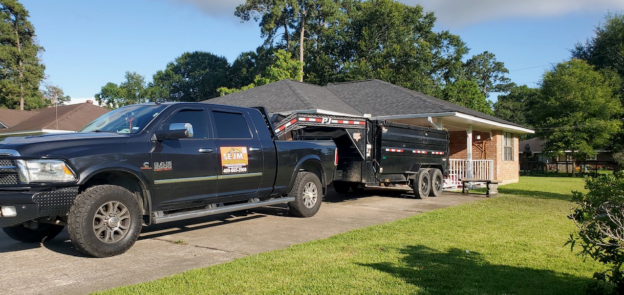 A black truck is parked in front of a house.