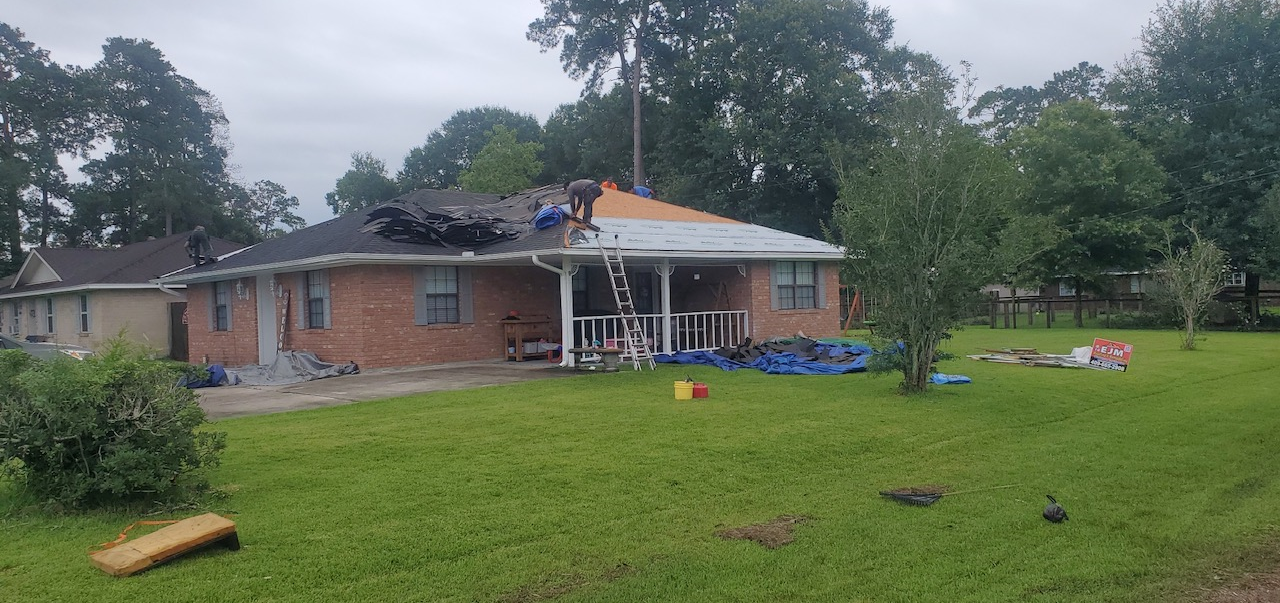 A house is being remodeled with a new roof.