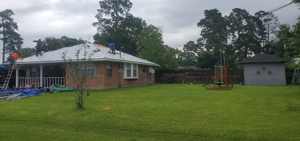 A house is being remodeled with a roof being installed.
