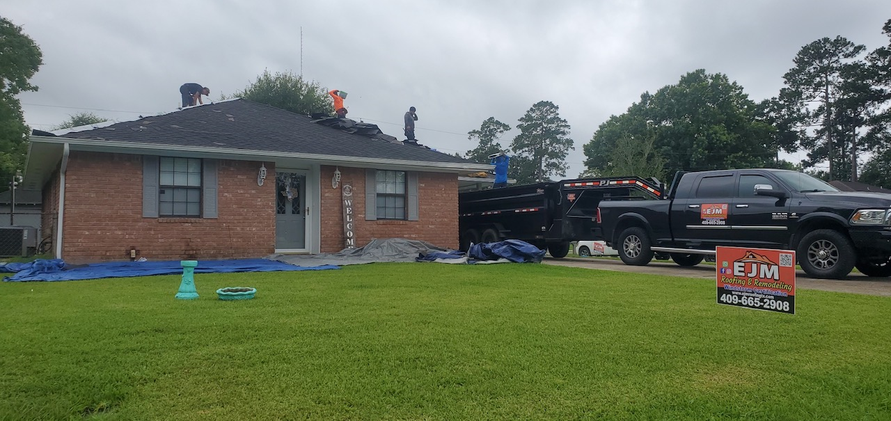 A brick house with a black truck parked in front of it.