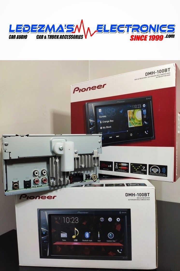 A pioneer car radio is sitting on a table next to its box.