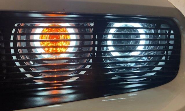 A close up of a car 's headlight that is lit up