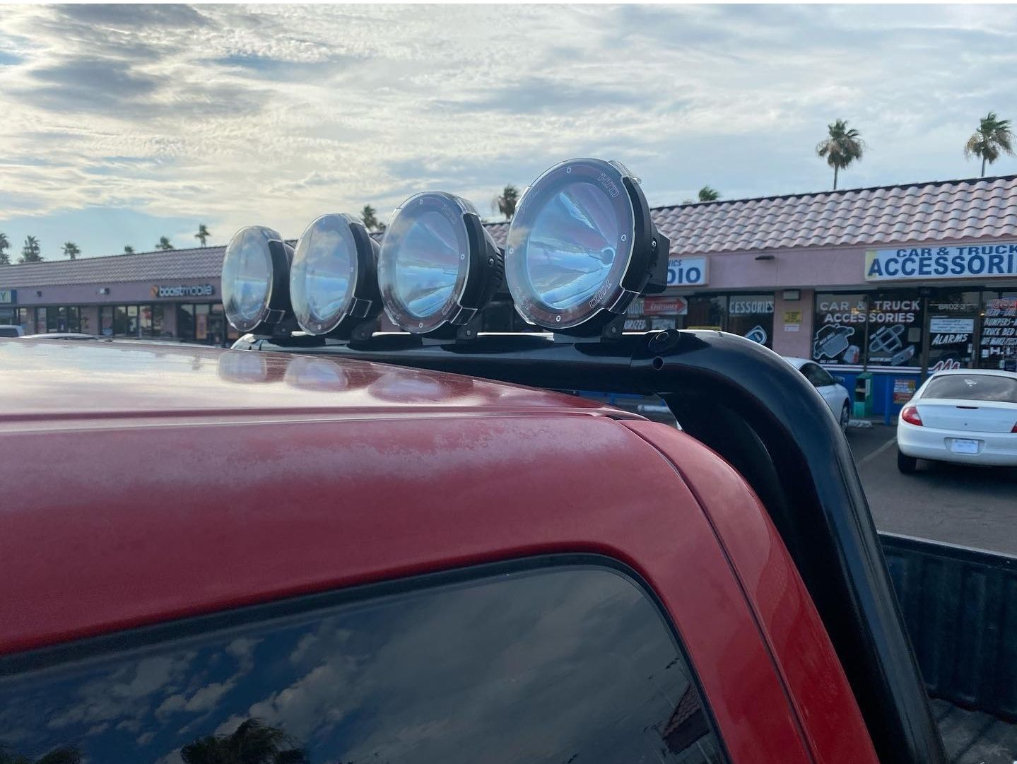 A red truck with a bunch of lights on top of it