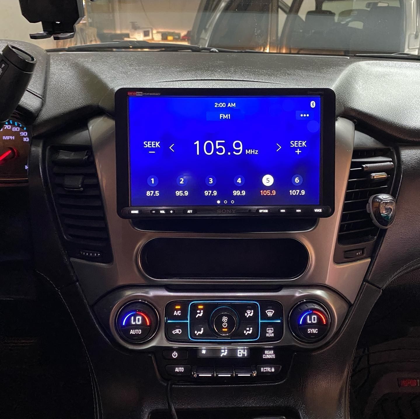 A car dashboard with a screen that says 105.9 on it