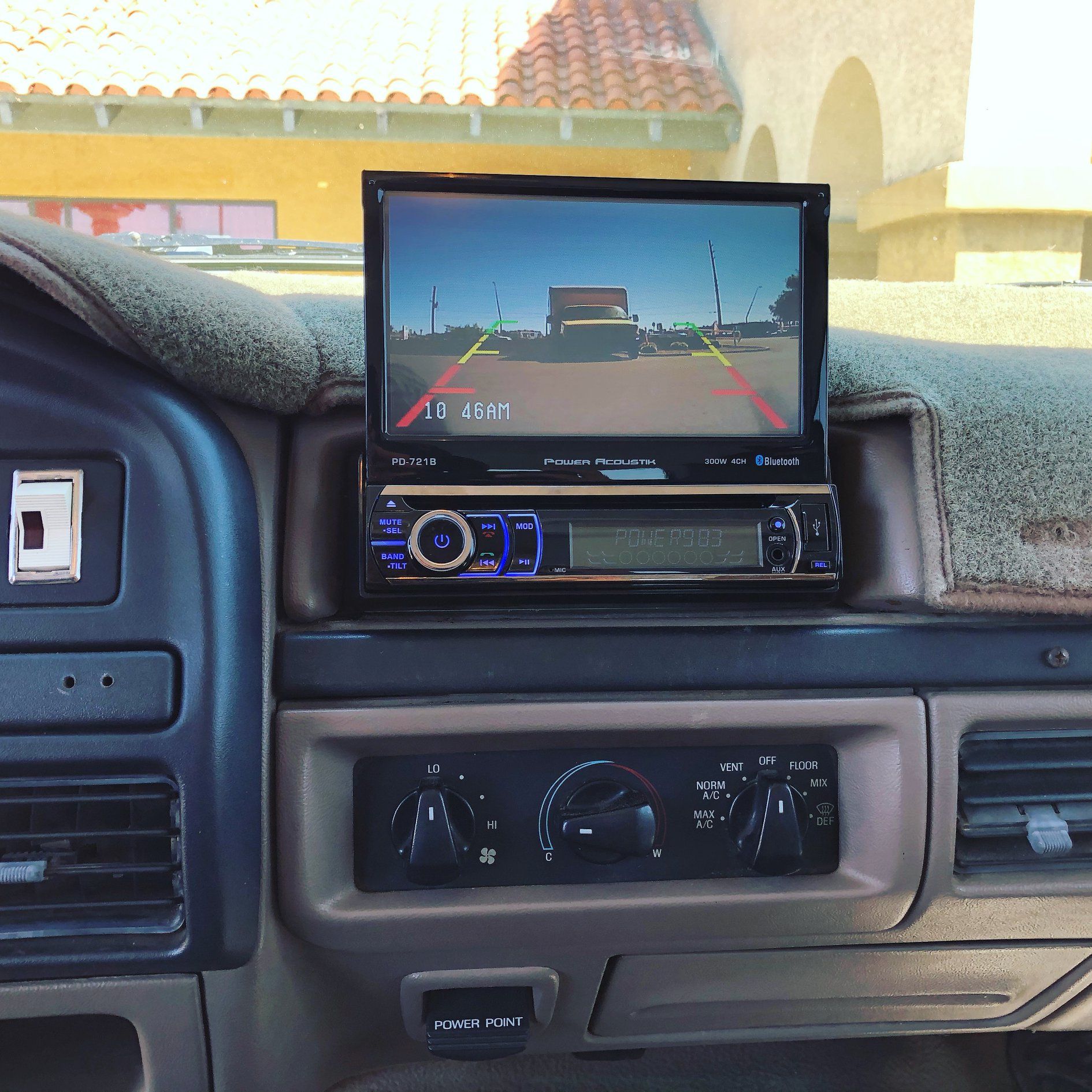 A car dashboard with a rear view camera on top of it