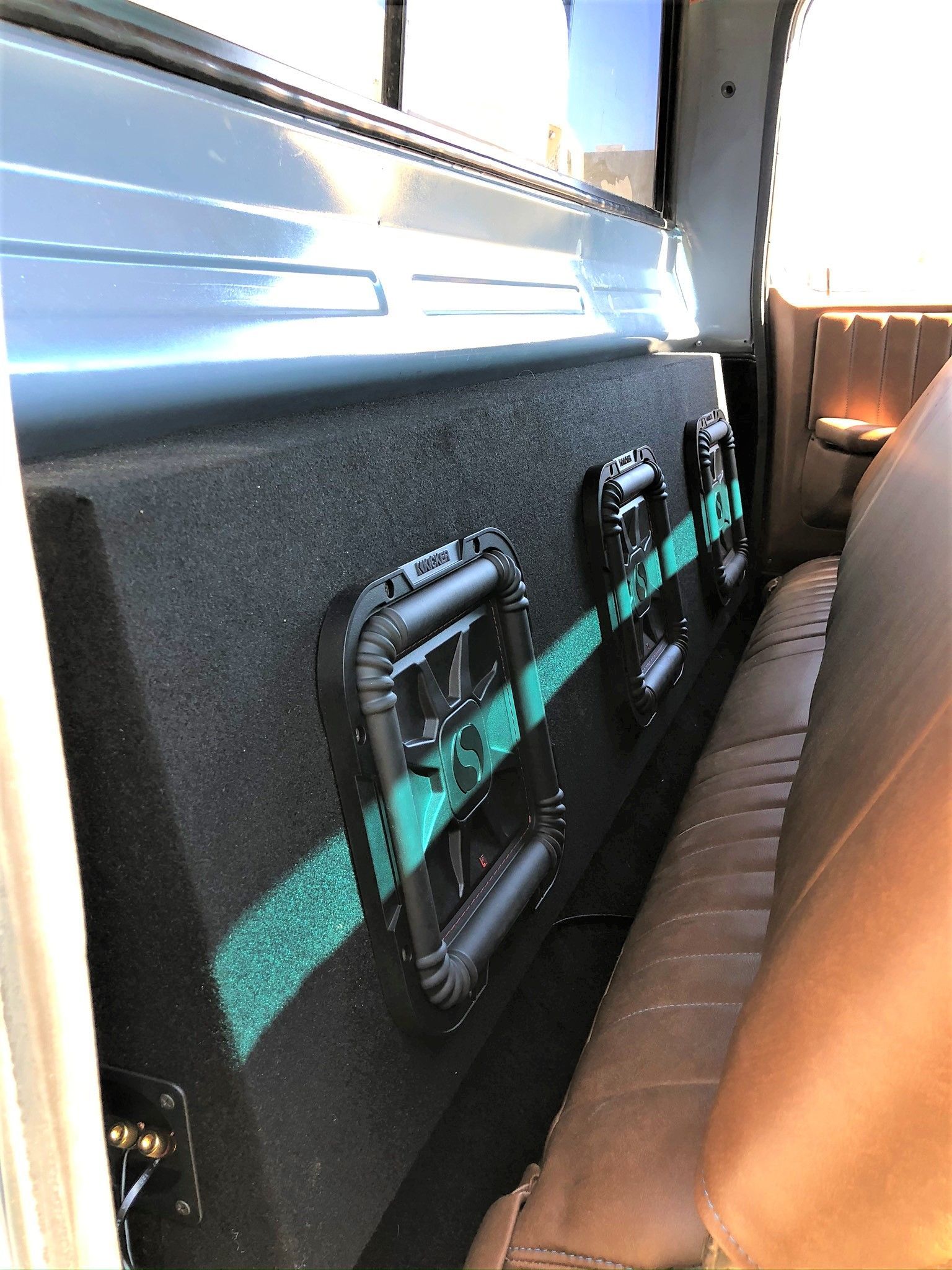 A truck with a subwoofer in the back of it.