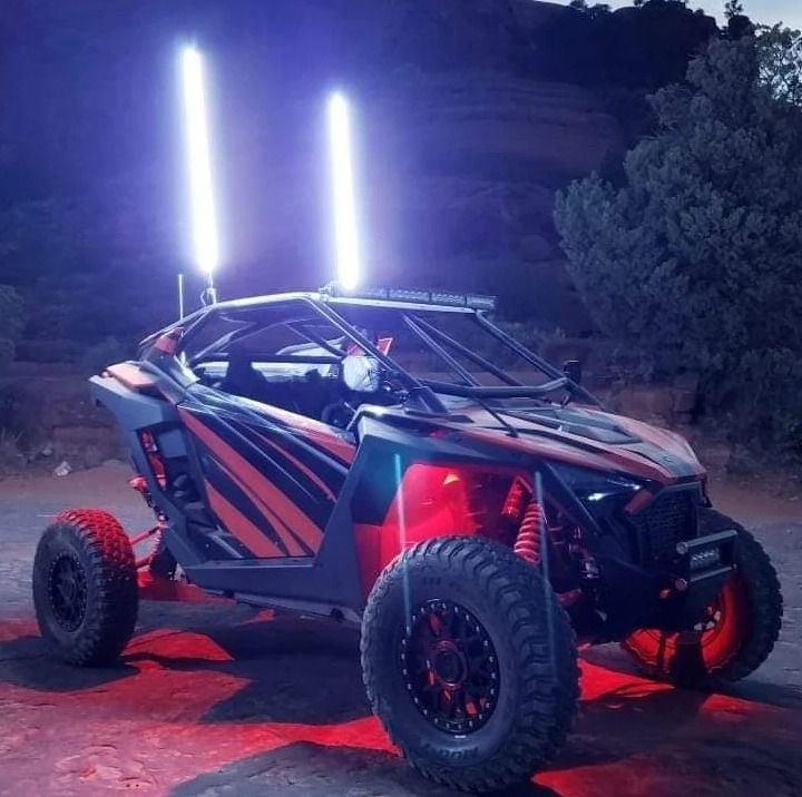 A red and black atv is parked in the dark