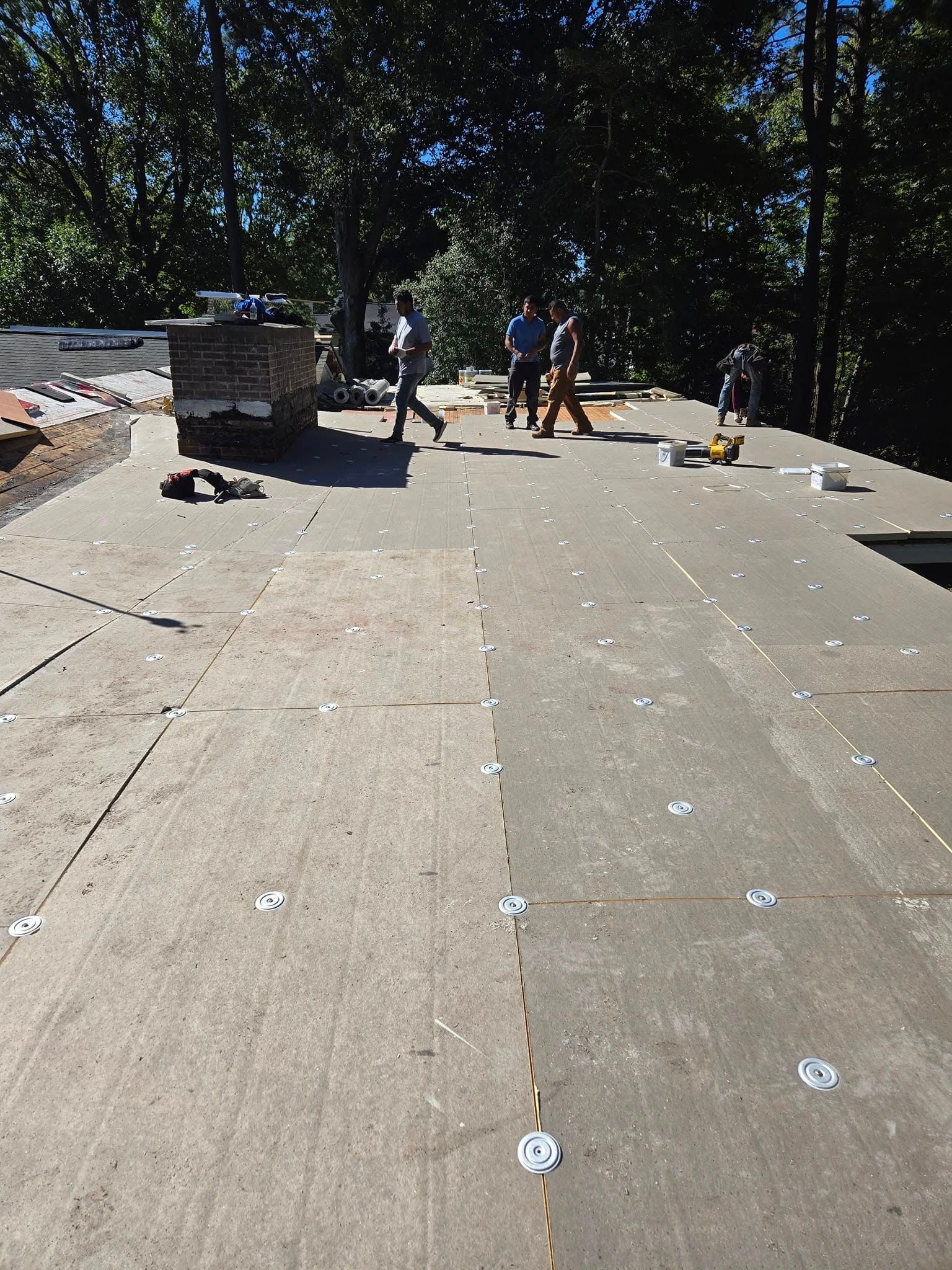 A group of people are working on a roof.
