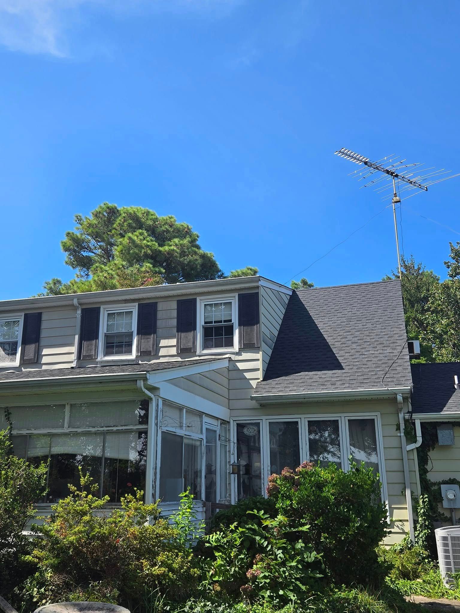 A house with a roof antenna on top of it