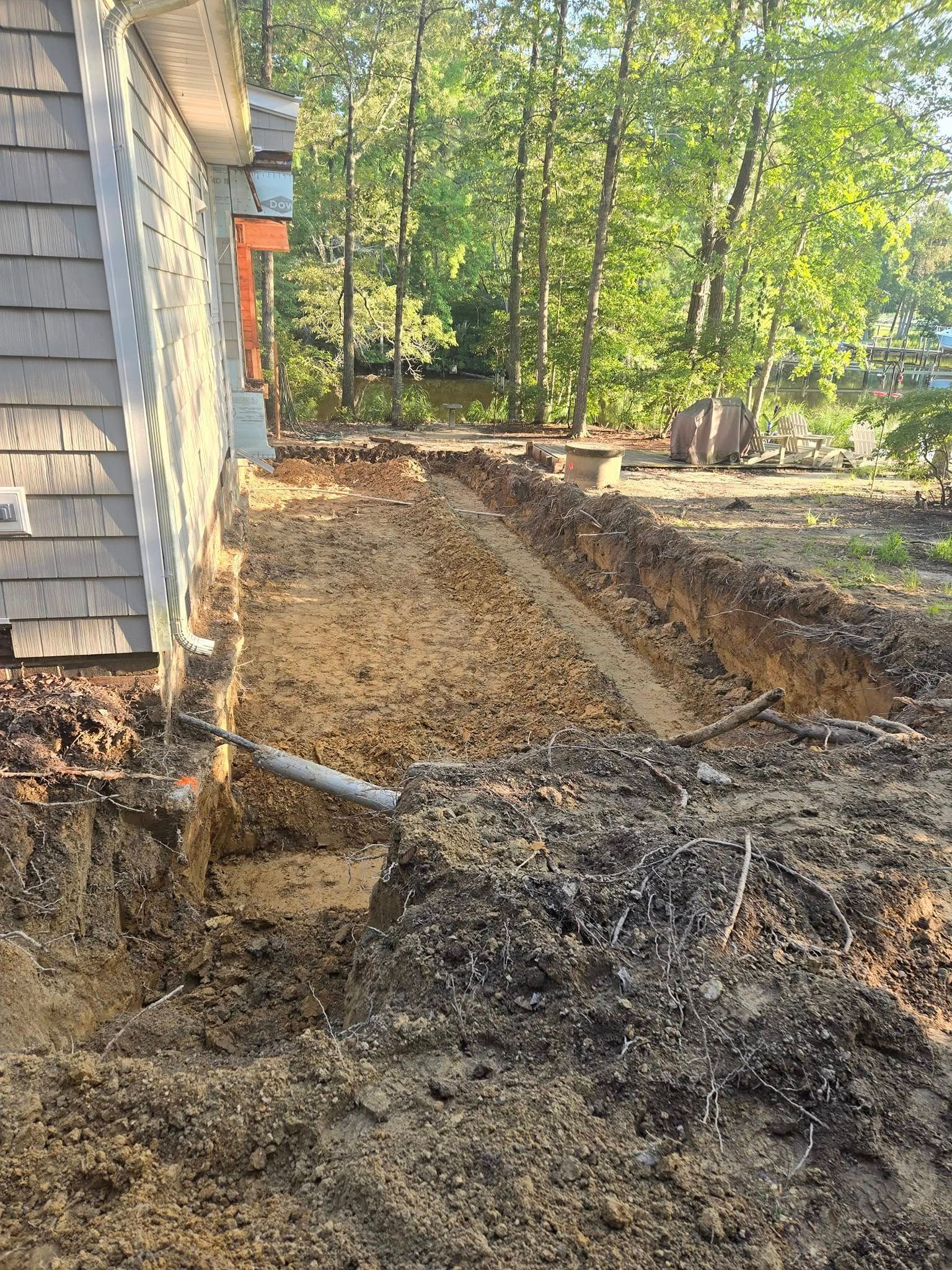 A large hole in the ground next to a house.