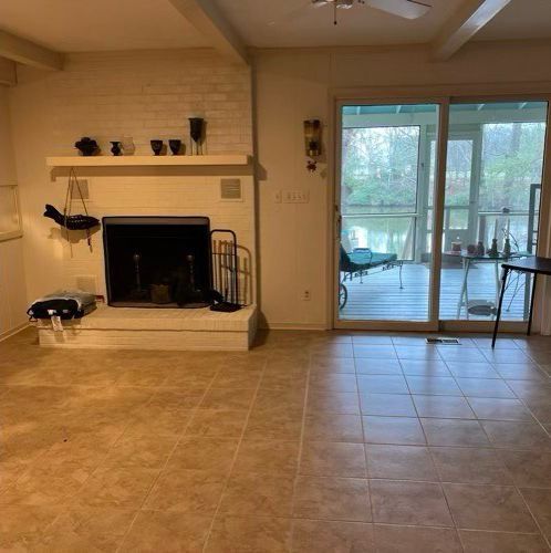 A living room with a fireplace and a sliding glass door.