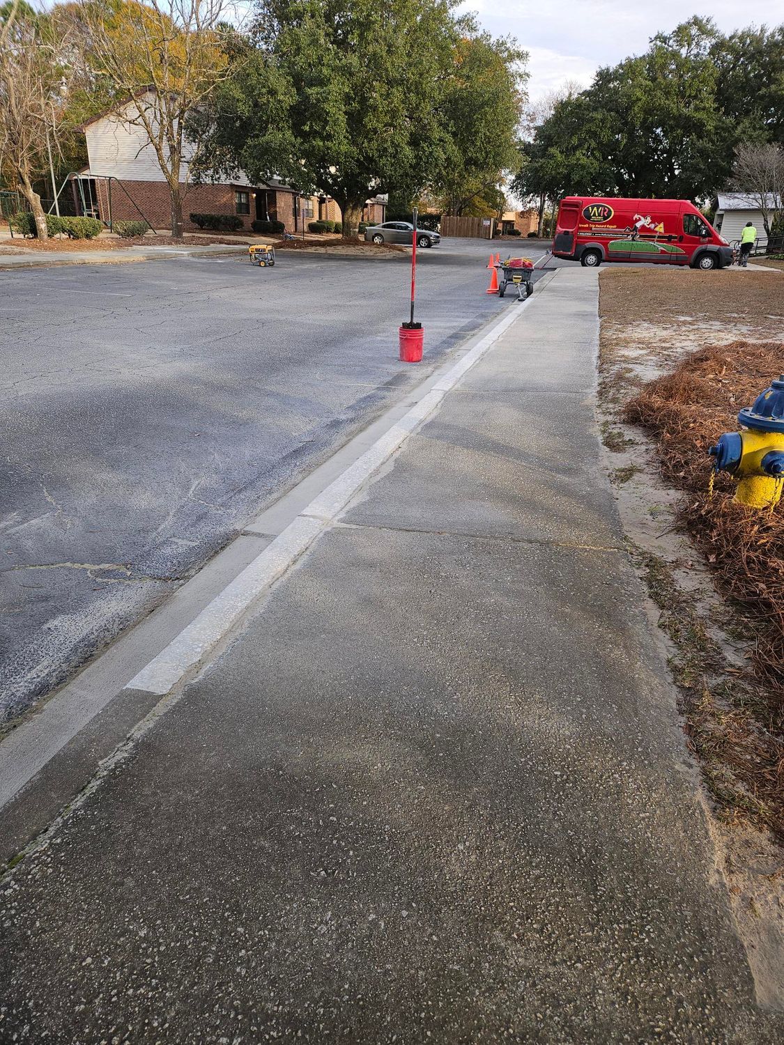 A concrete sidewalk is being built next to a fire hydrant.