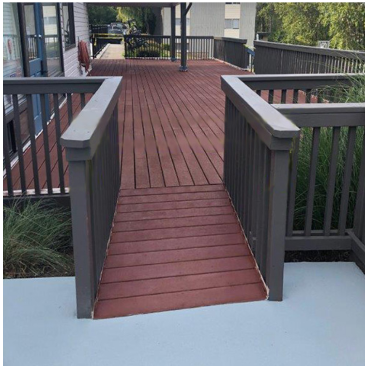 A wooden deck with a ramp leading to it