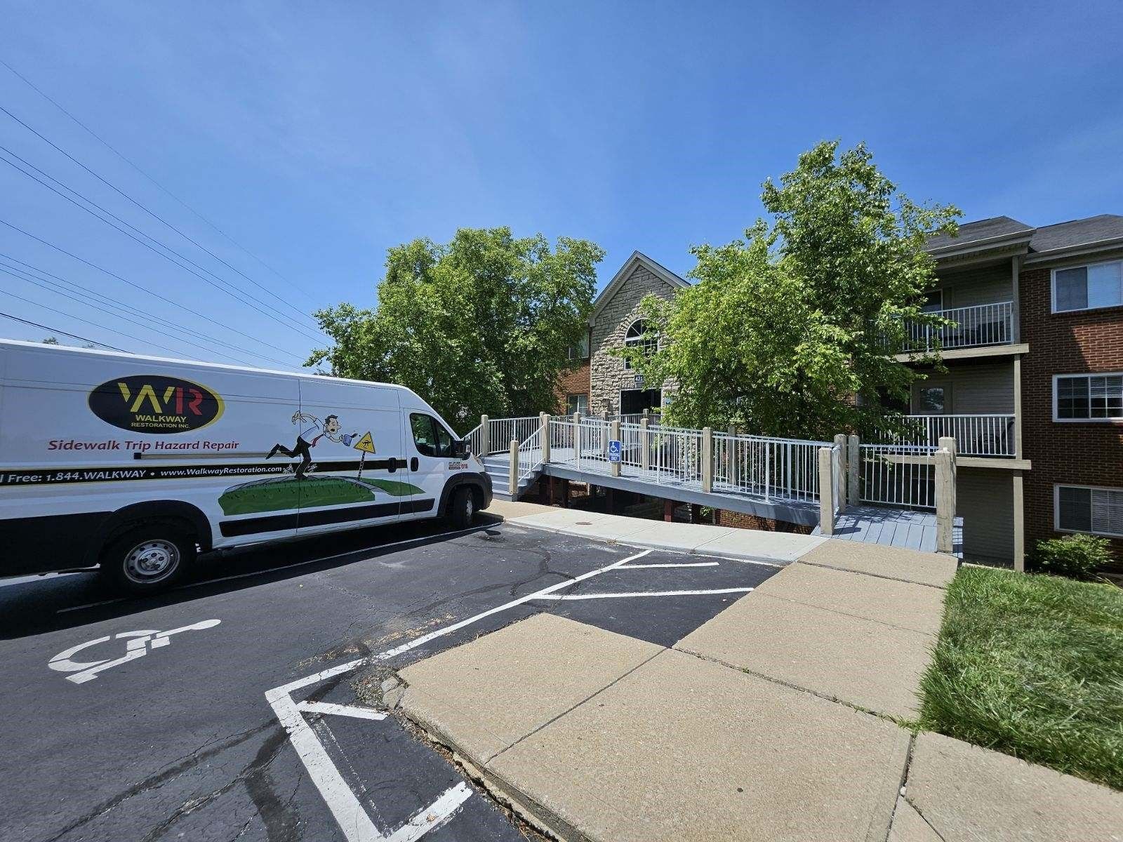 A white wr van is parked in front of a building