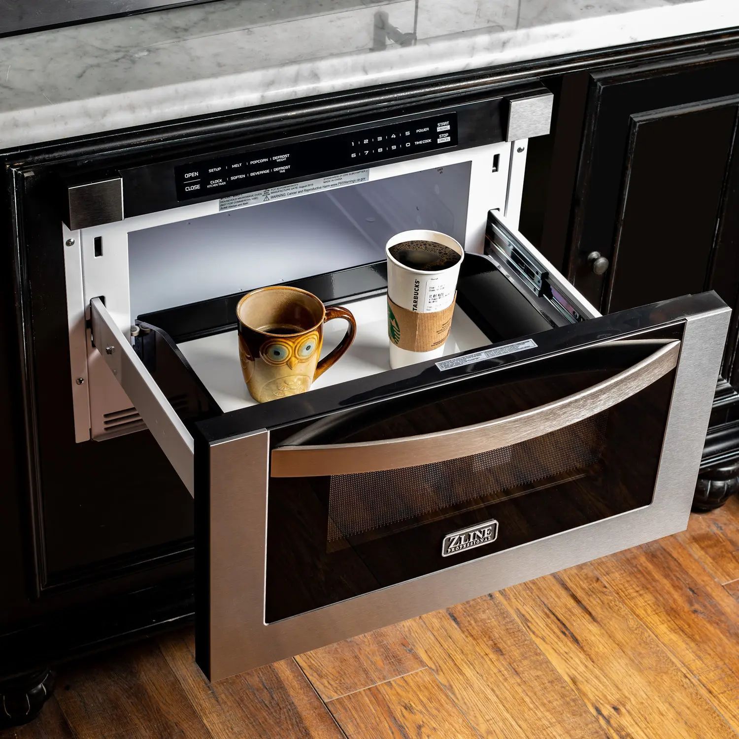 Black built-in kitchen drawer open with two coffee cups inside