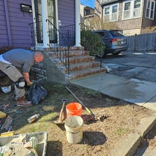 A man is working on the steps of a house