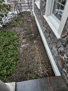 A house with a lot of dirt on the side of it