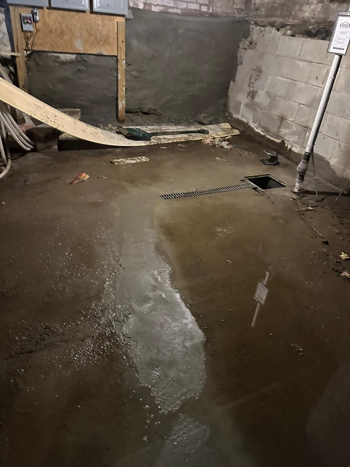 A flooded basement with a hole in the floor
