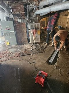 A group of men are working in a basement