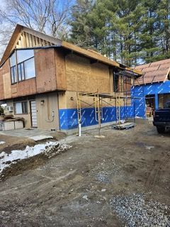 A house is being remodeled and a truck is parked in front of it