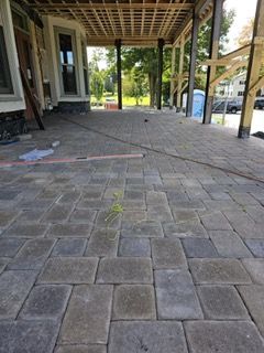 A brick walkway is being built in front of a house
