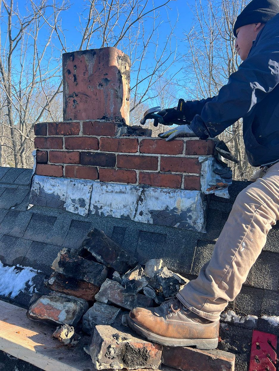 A man is repairing a brick chimney